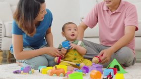 A family of three, a man and two women, are playing with toys on the floor. The baby is holding a toy truck and the parents are clapping. Scene is happy and playful	 - Powered by Shutterstock - Get 15% off with code: PIKWIZARD15