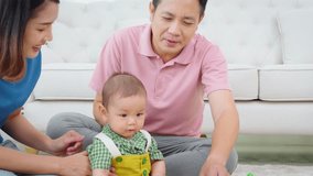 A family of three, a man and two women, are playing with toys on the floor. The baby is holding a toy truck and the parents are clapping. Scene is happy and playful	 - Powered by Shutterstock - Get 15% off with code: PIKWIZARD15