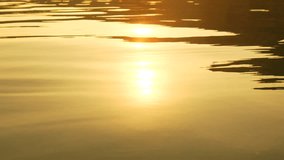Abstract sea summer ocean sunset nature background. Small waves on golden water surface in motion blur with golden bokeh lights from sun. Holiday, vacation and recreation. Weather and climate change - Powered by Shutterstock - Get 15% off with code: PIKWIZARD15