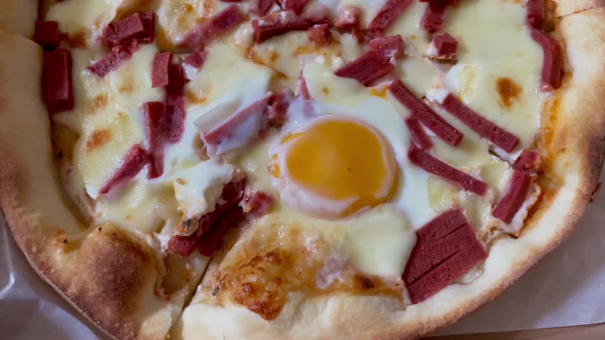 Australian pizza. Pizza with eggs, cheese and beef. Pizza in box. Junk food. Delicious food
