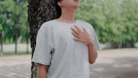 Asian tan man feel pain heart attack while exercise in garden. Attractive sportsman has difficulty breath clutching chest from acute pain while practice workout for health in park, exercise. - Powered by Shutterstock - Get 15% off with code: PIKWIZARD15