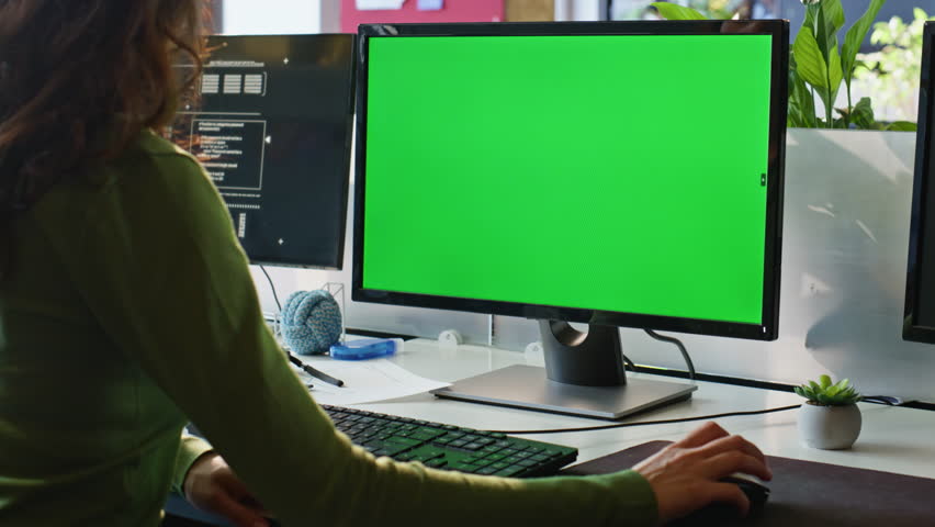 Employee watching greenscreen computer at remote workplace closeup. Unrecognizable businesswoman using mouse device with mockup pc in office. Unknown female working at chromakey digital gadget on desk