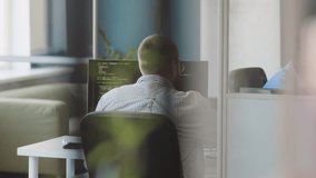 Two African American and Caucasian young men using computers at work in modern IT company office - Powered by Shutterstock - Get 15% off with code: PIKWIZARD15