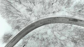 Beautiful aerial top-down view of snow covered pine forest and a road winding among trees. Rime ice and hoar frost covering trees. Scenic winter landscape near Vilnius, Lithuania. - Powered by Shutterstock - Get 15% off with code: PIKWIZARD15