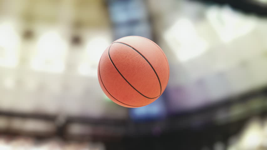 Basketball ball going through hoop net on a basketball arena. Slow motion 3d video animation. 3D Illustration