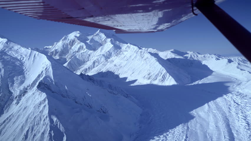 Point Of View Beautiful Shot Of Snow Covered Mountains In National Park Seen From Flying Air Vehicle On Sunny Day - Denali National Park, Alaska