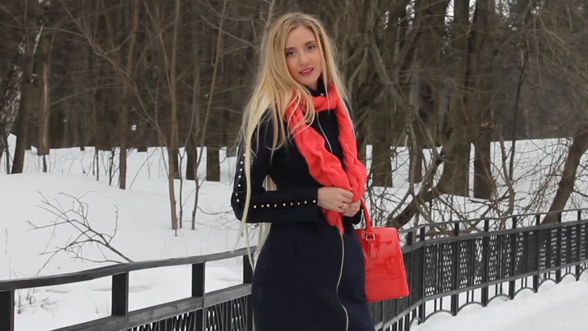 Blonde young woman in winter park