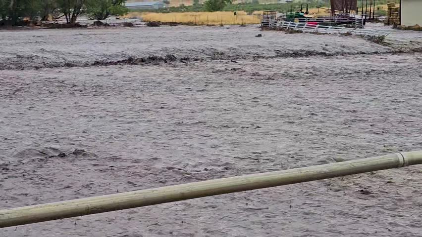 Flash flood from heavy monsoon rainstorm washes out farm field-Damages sprinkler line-Pan