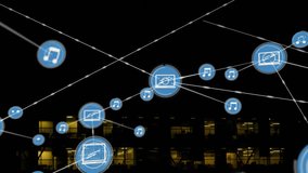 Network of connected devices and music icons animation over office building at night. Technology, connectivity, modern, innovation, smart devices, internet of things - Powered by Shutterstock - Get 15% off with code: PIKWIZARD15