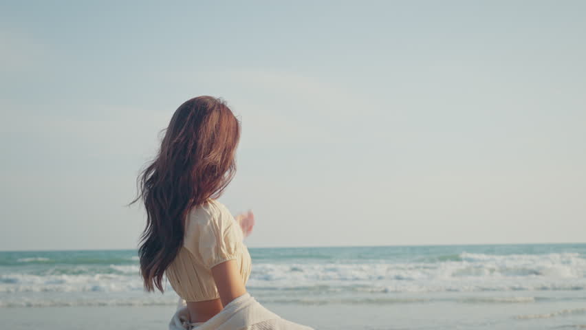 Happy asian woman walking on sea beach, Slow motion, Smiling cheerful lady have fun on seashore enjoy beautiful nature.