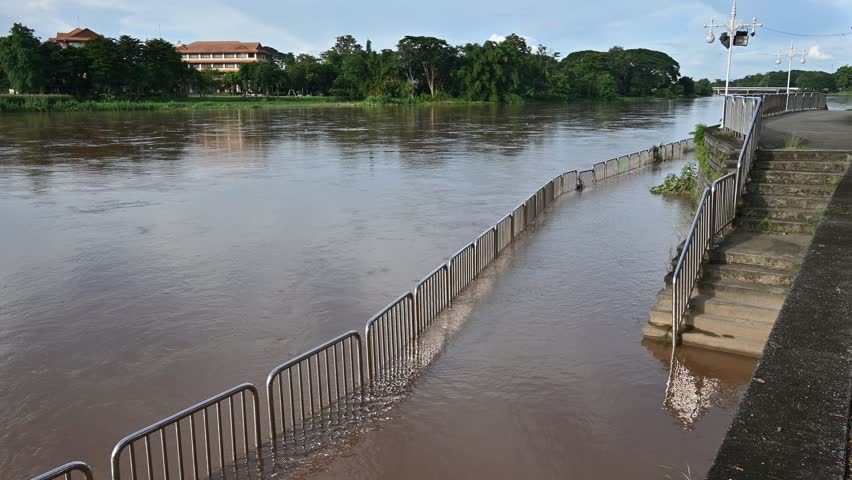Mae Kok river flood on pedestrian walkway in Chiang Rai province of Thailand during rainy season. This river is the blood line for people of Chiang Rai, started from the hills on boarder of Myanmar.