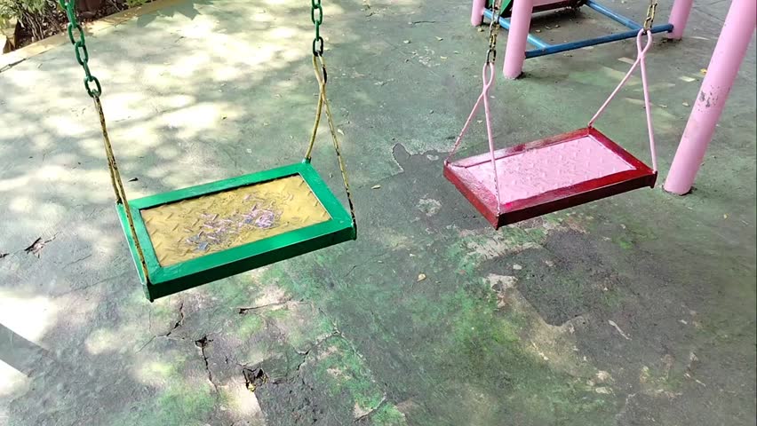 a swing blowing in the wind in the park