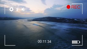 Camera interface animation over aerial view of serene coastal landscape at dusk. Technology, user interface, digital, innovation, virtual, futuristic - Powered by Shutterstock - Get 15% off with code: PIKWIZARD15