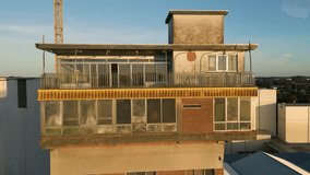 forward-moving aerial shot abandoned industrial site tower during sunset decaying structure contrast vibrant colors setting sun, creating aerial view ruins urban exploration industrial decay - Powered by Shutterstock - Get 15% off with code: PIKWIZARD15