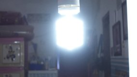 CU of lights turn on in the living room. Turn on the spiral bulb at night - Powered by Shutterstock - Get 15% off with code: PIKWIZARD15