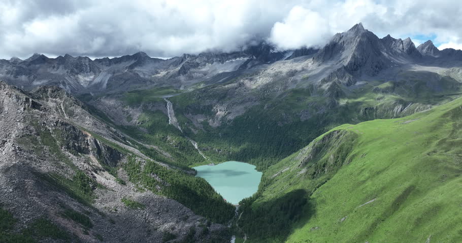 Aerial footage of beautiful high altitude grassland and mountain landscape