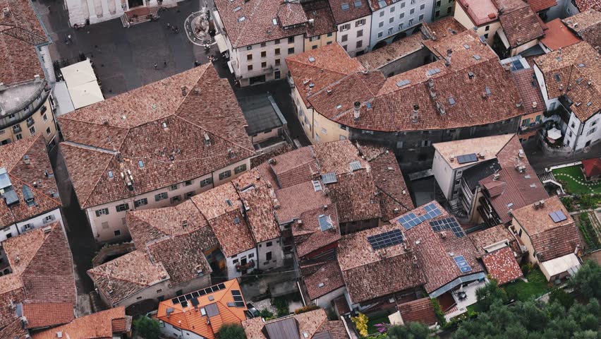 Camera moving above italian town with market in central square
