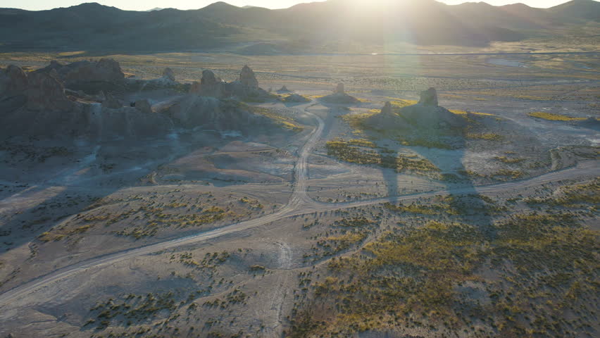 Cinematic aerial shot of wildflower super bloom covering Trona Pinnacles at sunrise in Mojave Desert in California, USA