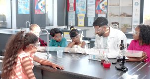 Science teacher demonstrating experiment to children over animation of chemical formulas. Education, chemistry, students, learning, demonstration, classroom - Powered by Shutterstock - Get 15% off with code: PIKWIZARD15
