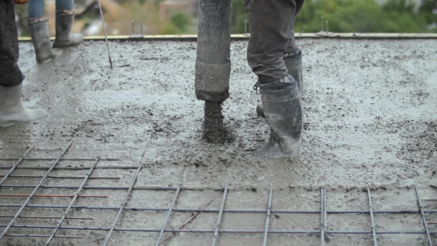 Workers pouring concrete at a construction site