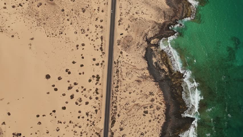 Aerial view of beautiful sand dunes and coastline at sunset, Parque Natural de Corralejo, Fuerteventura, Spain.