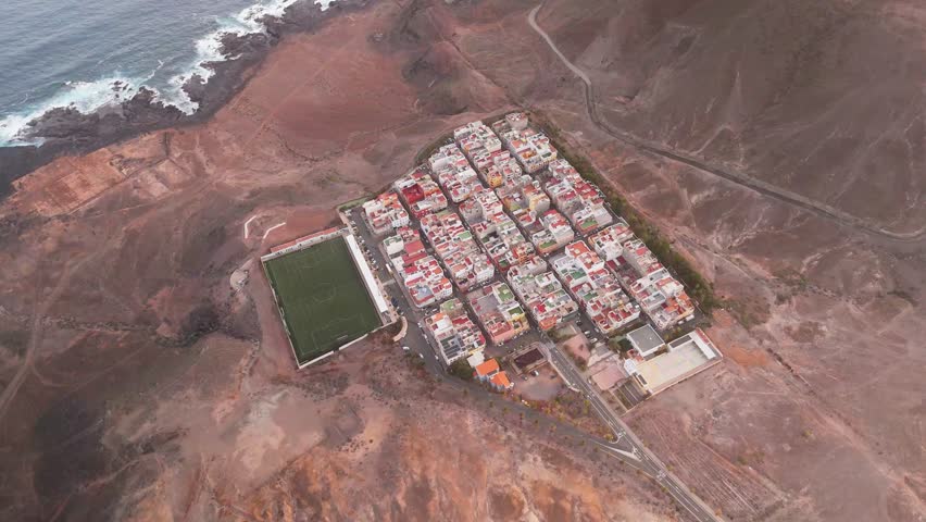 Aerial view of Las Coloradas Stadium surrounded by residential buildings and coastal hills, Las Palmas de Gran Canaria, Spain.