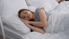Asian beautiful woman lying down on bed in bedroom, dreaming in morning. Attractive young female in pajamas sleeping alone on comfortable pillow and cozy blanket in the room for health care at home. - Powered by Shutterstock - Get 15% off with code: PIKWIZARD15