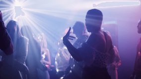 Fancy men and women dancing at the party in the night club surrounded by vibrant lights reflecting from disco ball - Powered by Shutterstock - Get 15% off with code: PIKWIZARD15