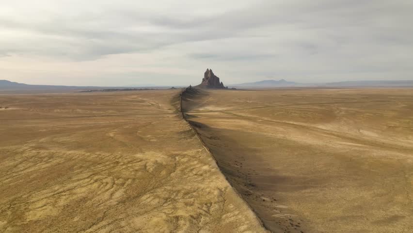 Aerial view of ship rock in golden hour with majestic volcanic rift, Shiprock, New Mexico, United States.
