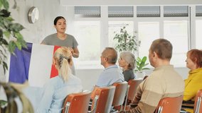 Geography lesson in university class - teacher talks about France, holding a flag in his hands. High quality 4k footage - Powered by Shutterstock - Get 15% off with code: PIKWIZARD15