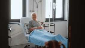 The cute granddaughter visits her grandmother in the hospital, enters the room, and brings her a bouquet. Grandchildchild visiting a grandparent in the hospital - Powered by Shutterstock - Get 15% off with code: PIKWIZARD15