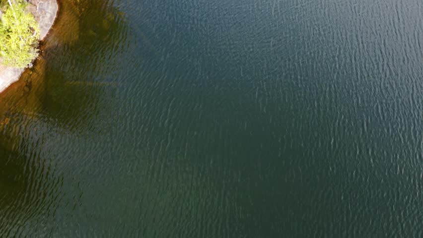 Russia, Lake Ladoga, Koyonsaari. View of the coast of the island in a cold lake. Beautiful nature of the Republic of Karelia. Panoramic view from the height of the Ladoga skerry islands. 4K