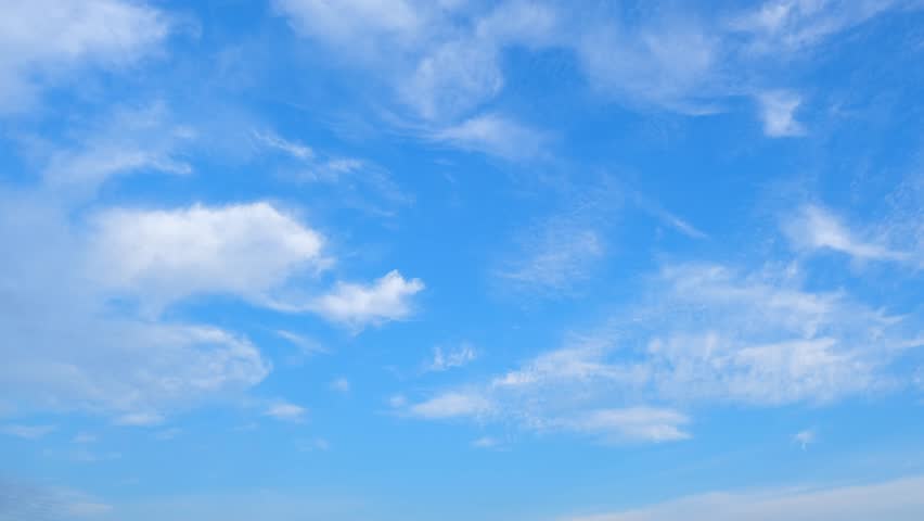 Timelapse : Witness the ethereal ballet of cerulean clouds as they gracefully form and drift in the vast expanse of the heavens, a celestial masterpiece unfolding. Time lapse. Sky background.
