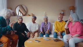 Group of senior friends playing cards in the living room.  - Powered by Shutterstock - Get 15% off with code: PIKWIZARD15