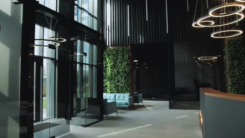 A modern office lobby with greenery and contemporary design, emphasizing comfort and luxury