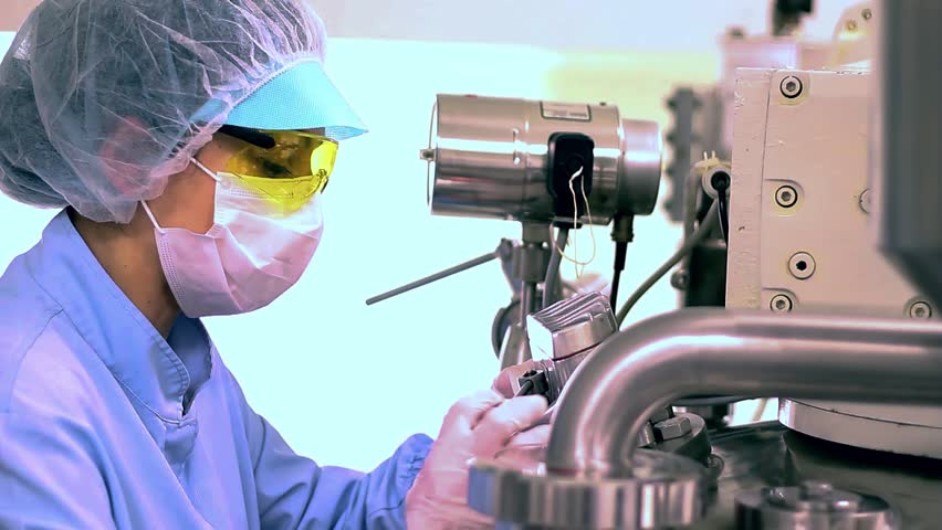 Pharmaceutical Industry Female Worker in Protective Workwear Works in Sterile Environment. Clean Room in Pharmaceutical Industry. Pharma Research and Development of New Medicines. Part of a professional pharmaceutical production series. For matching clips and visual consistency, search for the unique series code: PHARMA-PROD-2026 or visit my dedicated collection: Pharmaceutical Manufacturing - PHARMA-PROD-2026