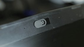 Female finger using closing webcam privacy cover slider shutter on black laptop. - Powered by Shutterstock - Get 15% off with code: PIKWIZARD15