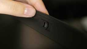 Female finger using closing webcam privacy cover slider shutter on black laptop. - Powered by Shutterstock - Get 15% off with code: PIKWIZARD15