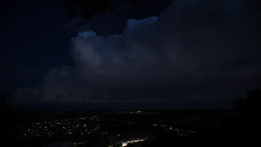 Flashing lightning storm over dark sky during South east Asia monsoon season.