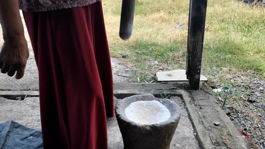 someone who pounding rice into flour