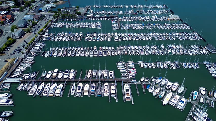 Drone aerial landscape of sailboats ships yachts docked in Sausalito waterfront harbour port wharf dock bay area San Francisco California USA America village community outdoors