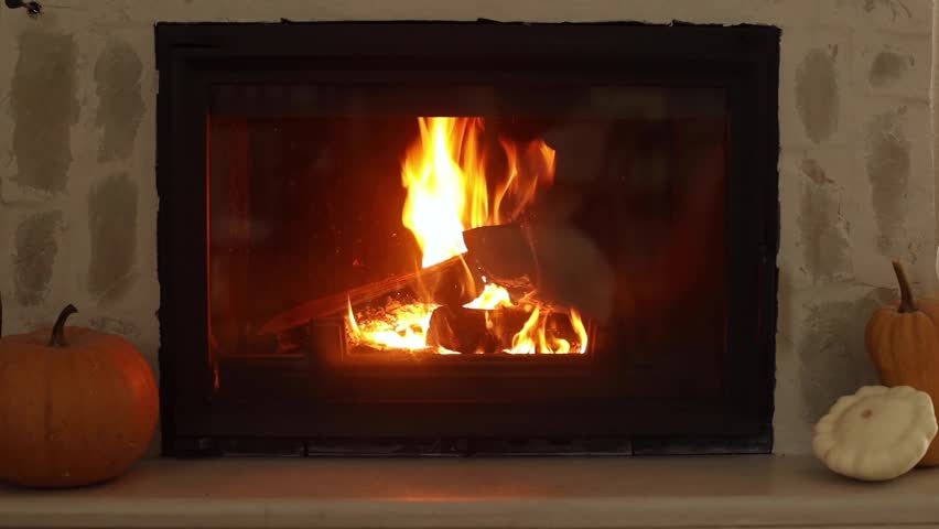 Close up of fireplace with pumpkins in modern farmhouse living room. Cozy autumn at fireside. Fall footage. Thanksgiving and Halloween