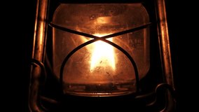 A detailed close-up of a cold-blast kerosene lantern, focusing on the warm, flickering flame within the glass enclosure. The image captures the intricate metalwork and the soft glow of the lantern. - Powered by Shutterstock - Get 15% off with code: PIKWIZARD15