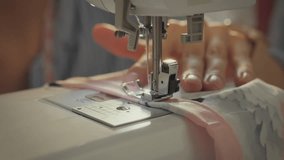 Workshop. White Asian woman using sewing machine while developing collection concept. Modern lady following fashion trends while sewing new dress model. Close-up of sewing needle movement - Powered by Shutterstock - Get 15% off with code: PIKWIZARD15