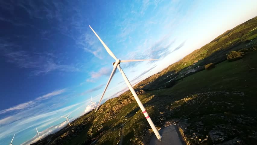 FPV Drone Shot of Win Turbine Spinning on Sunny Day in Landscape of Scandinavia