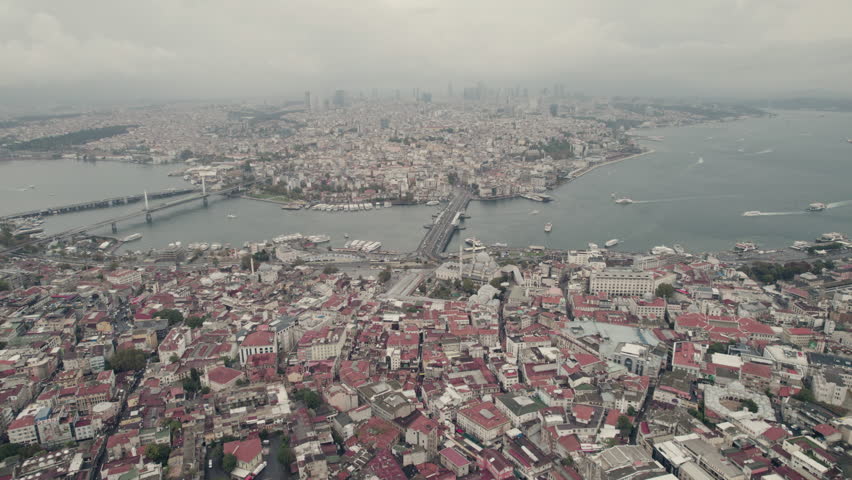 Panoramic aerial view of Istanbul city under rainy stormy sky, from Galata Bridge at the Golden Horn