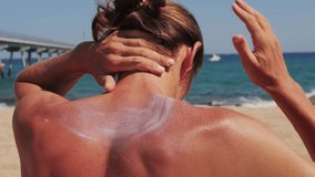 Muscular man Applying Sun Cream on Tanned Shoulder In Form near the beach. Sun Protection close up, Cream. Skin and Body Care. Handsome man using sunscreen. - Powered by Shutterstock - Get 15% off with code: PIKWIZARD15