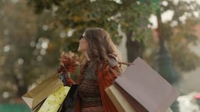 Hello october. happy trendy woman in brown trench coat with shopping bags and autumn yellow leaves in the city. - Powered by Shutterstock - Get 15% off with code: PIKWIZARD15
