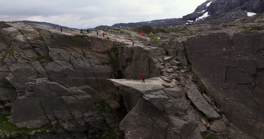Hiker Walking Away from Trolltunga Cliff Ledge after taking photo.