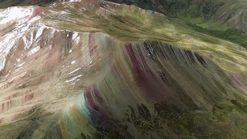 The vibrant colors of palcoyo rainbow mountain in peru under a clear sky, aerial view